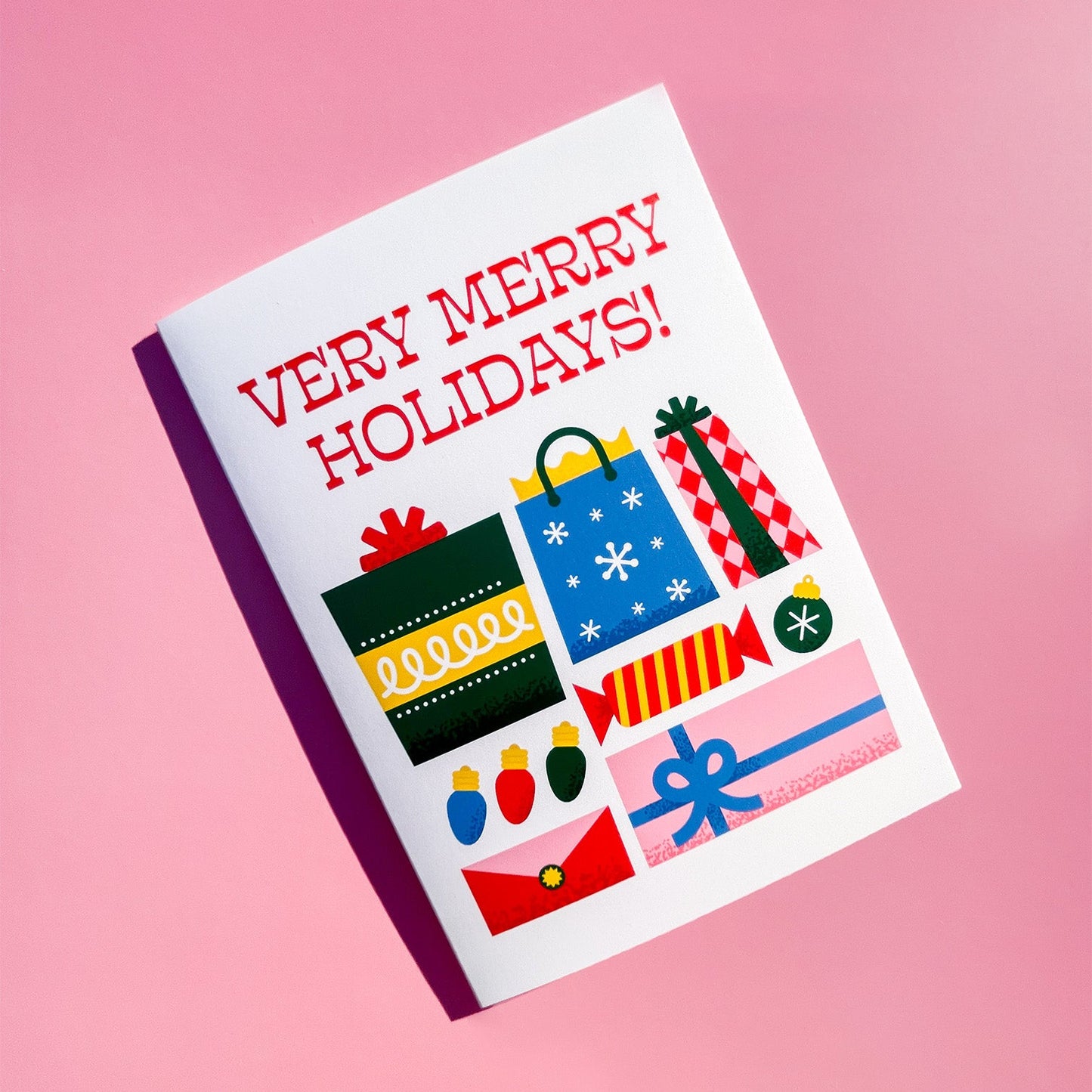 Holiday card with festive illustrations of presents and 'Very Merry Holidays!' in red text on a pink background