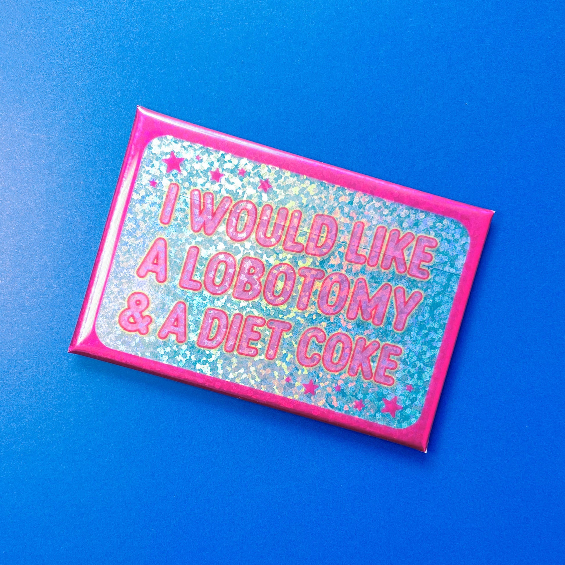 Glittery rectangle magnet with text 'I would like a lobotomy & a diet coke' on a blue background