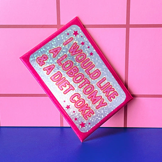 Glittery rectangular magnet with text 'I would like a lobotomy & a diet coke' propped against pink tiled background