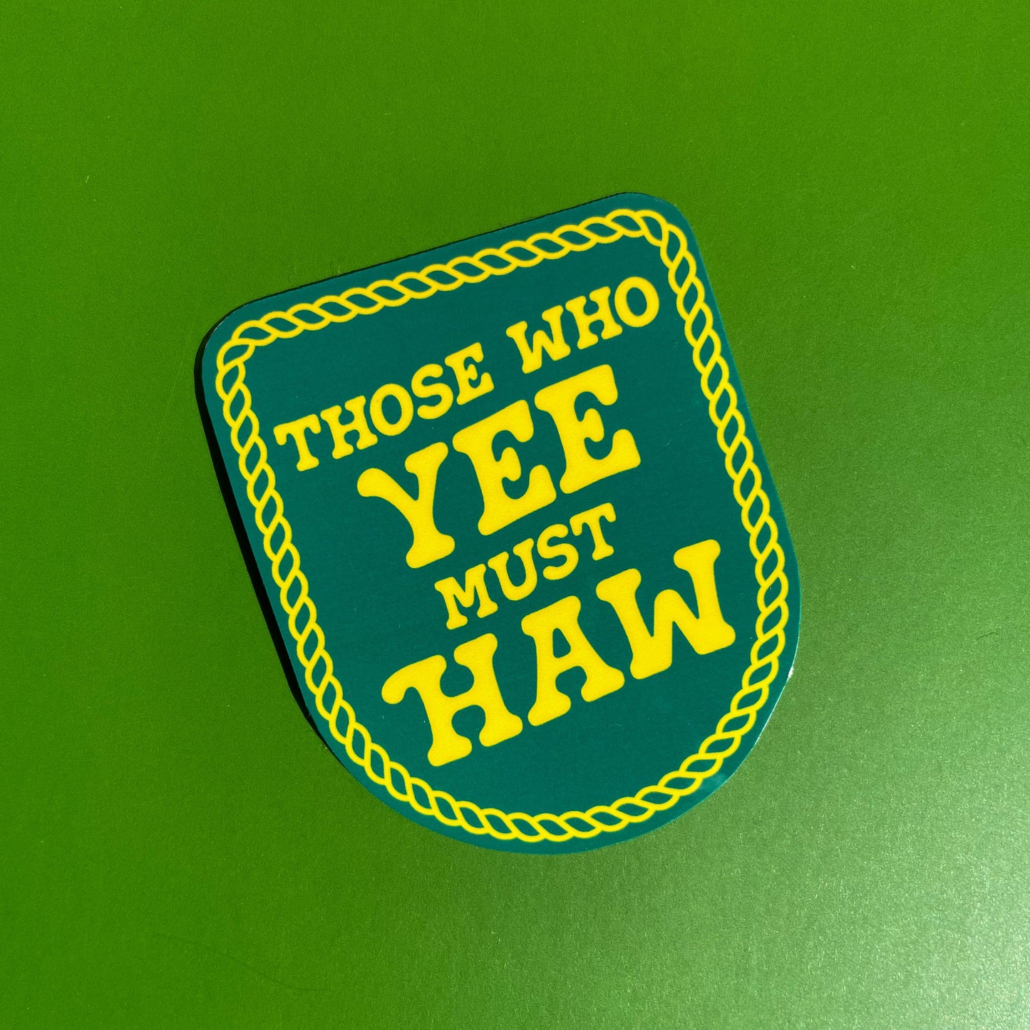 Sticker designed to look like a patch  with 'Those Who Yee Must Haw' text on a green background