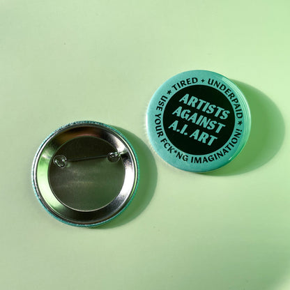 Button badge with 'Artists Against A.I. Art' text on a light green background