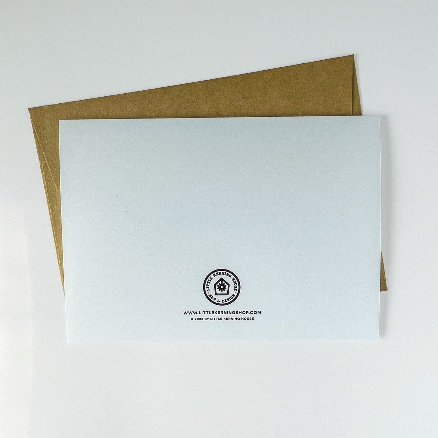 White card with a logo and text on a brown envelope against a white background