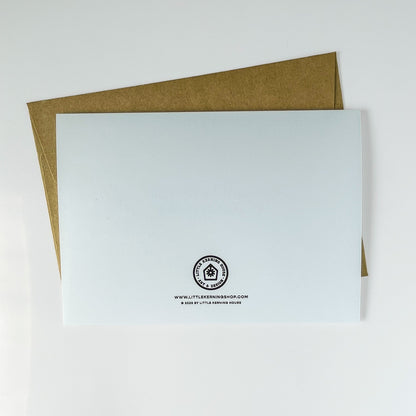 White card with a logo and text on a brown envelope against a white background